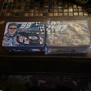 Two racing tins number 97and 99 one new in plastic other out of plastic